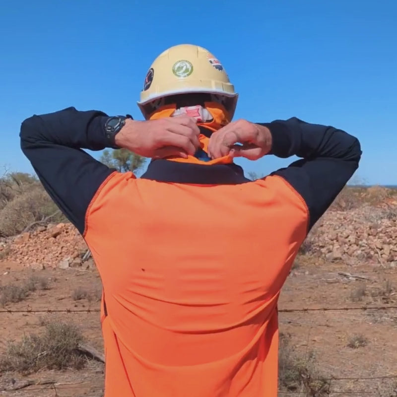 Outdoor worker using frozen gel packs for heat stress cooling with an outback mask